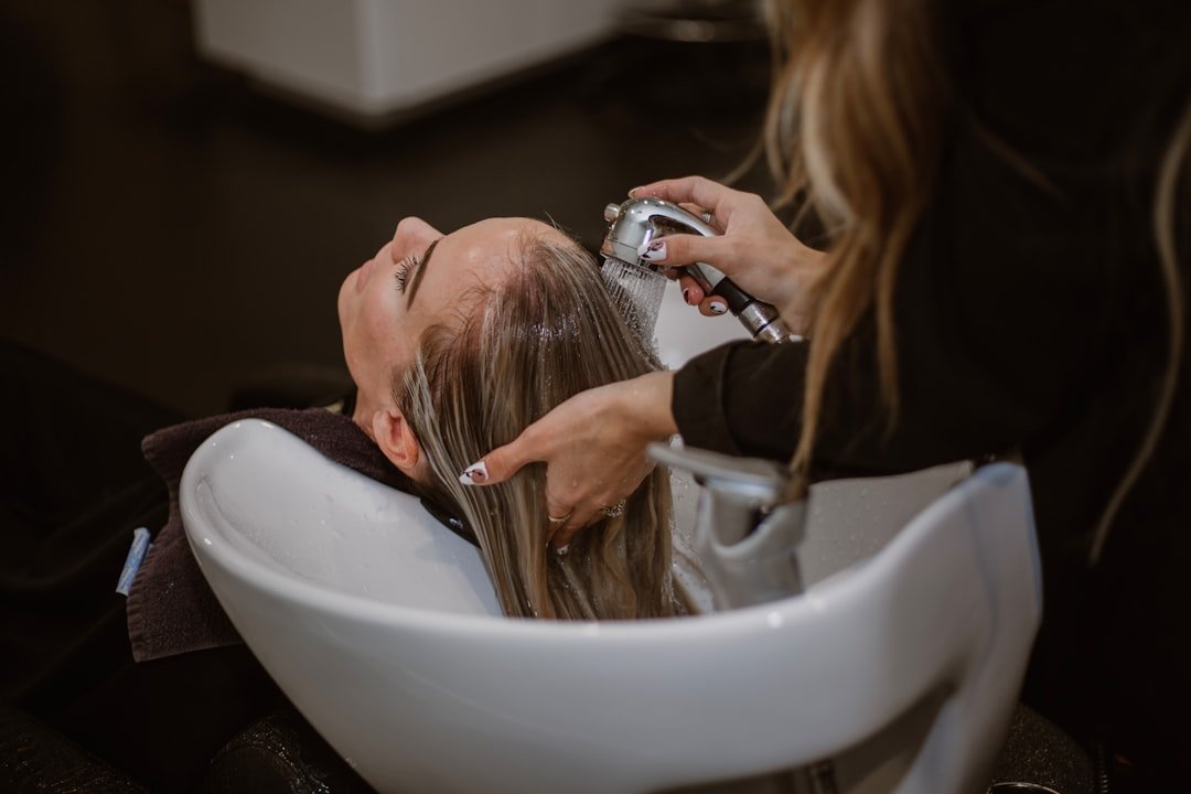 services-02 a-woman-getting-her-hair-cut-by-a-hair-stylist-md-dhafsncq