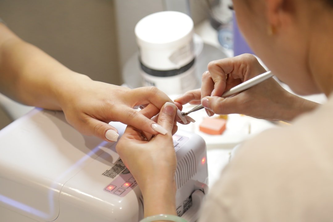 about-02 a-woman-getting-her-nails-done-at-a-nail-salon-gb6gtitzkb8