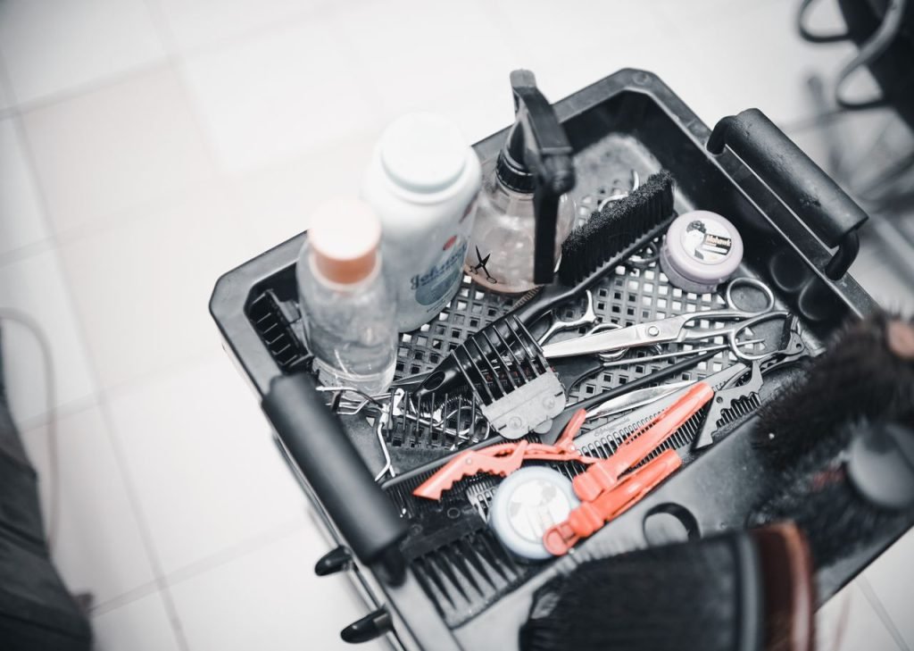 tray-with-hairdresser-tools-18186517 A selection of hairdressing tools and products arranged in a salon trolley for professional use.